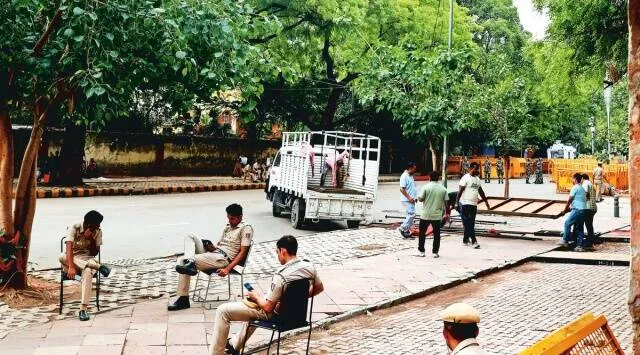 Police cart away tents, mattresses in trucks and tempos, Sunday. Amit Mehra